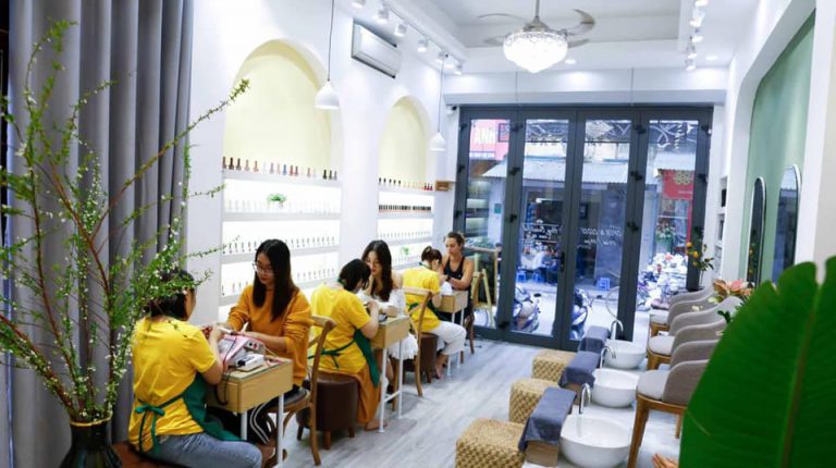Nail salon interior with manicure tables and pedicure chairs